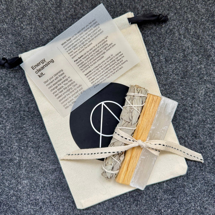 Energy clearing kit with tools and instructions on a gray surface